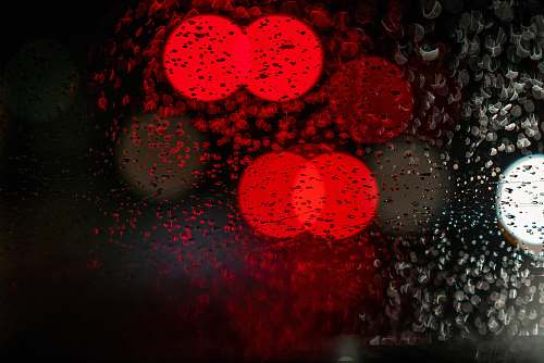 red light red light seen through glass panel wet